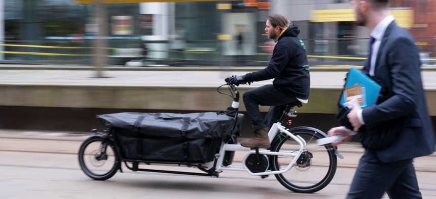 A staff member rides an electric bike during an eCargo bike launch in Manchester, Britain, on Jan. 17, 2022. A U.S. safety group is telling cities they should prepare for new types of vehicles on their streets, possibly including bulkier bikes like these.
