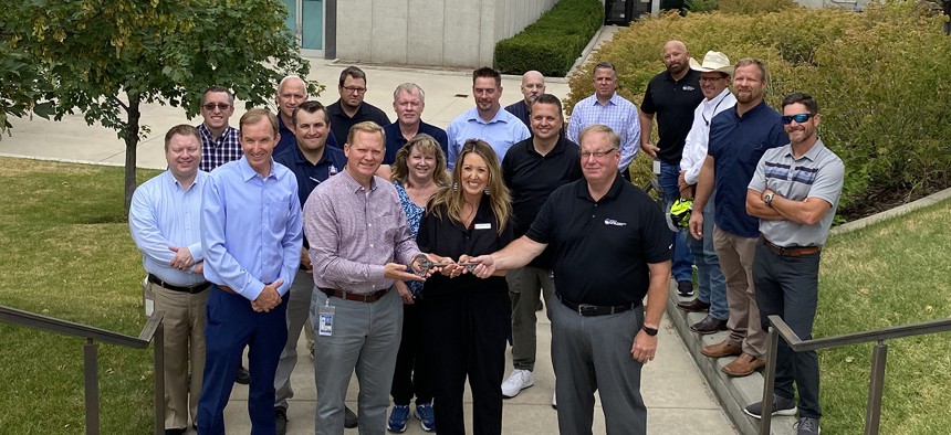 The Utah Division of Technology Services team handing over the key to the building they vacated.