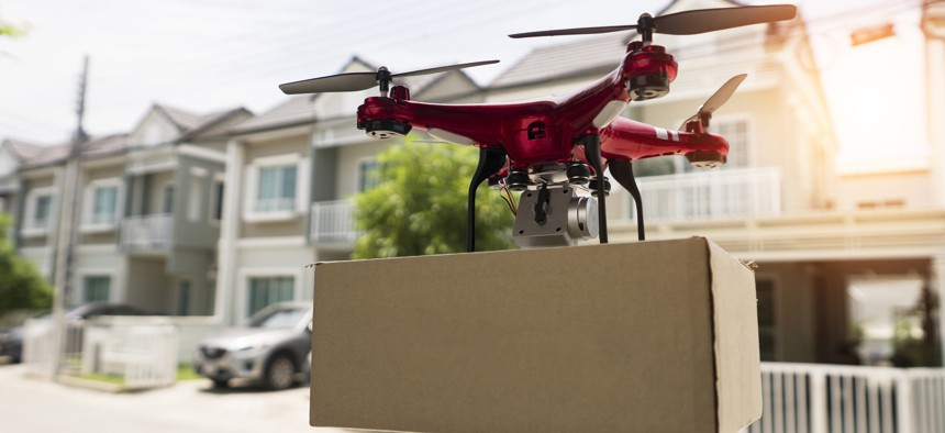 Delivery drone carrying urgent shipment box.