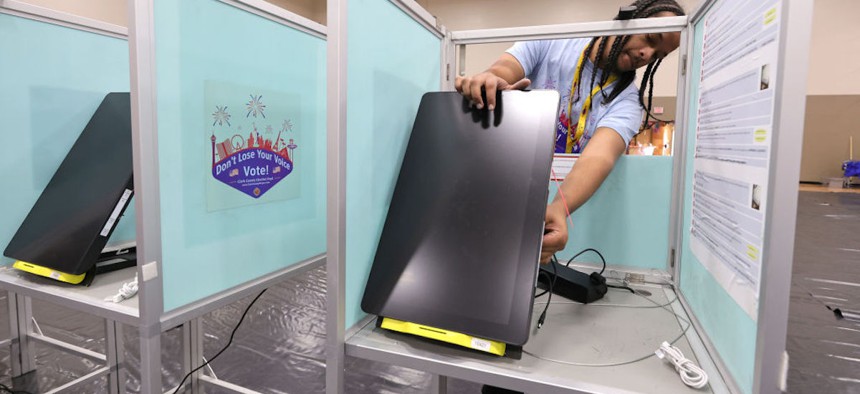 A Clark County Election Department worker sets up a voting machine at a polling place at Desert Breeze Community Center on October 21, 2022 in Las Vegas, Nevada.