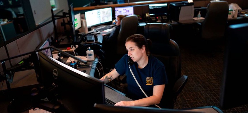 A dispatcher with Anne Arundel County Fire Department answers a 911 emergency call from their department dispatch center on April 14, 2020 in Glen Burnie, Maryland.