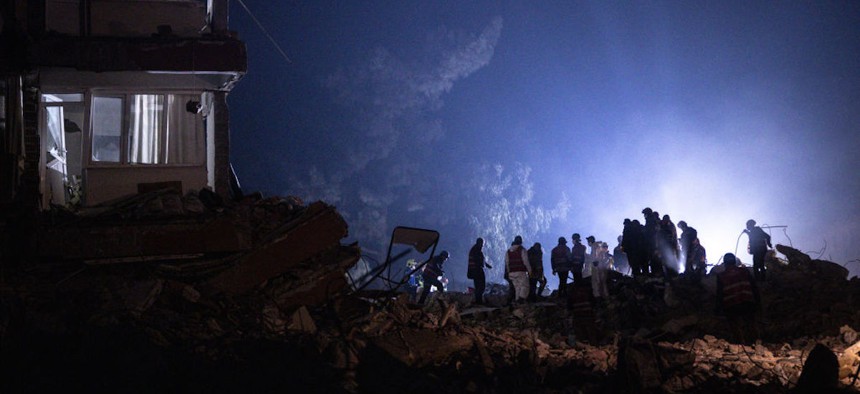 Rescue workers search for survivors at a destroyed building on February 14, 2023 in Hatay, Turkey.