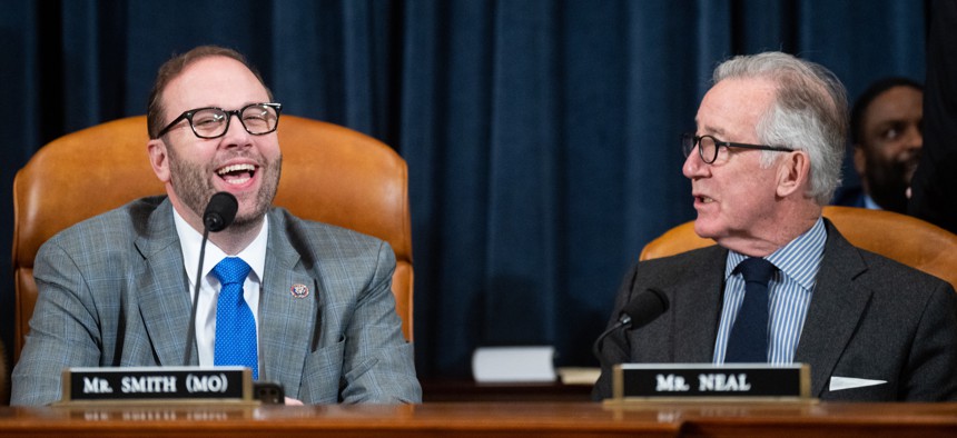 House Ways and Means Chairman Jason Smith (R-Mo.) and Ranking Member Richard Neal (D-Mass.) talk during the committee organizing meeting on Jan. 31, 2023. The pair are at odds over new legislation meant to recapture fraudulent pandemic payments. 